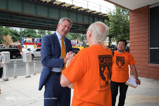 Mayor Bill de Blasio greets a housing advocate on the day he signs the right to counsel law on August 11th, 2017.